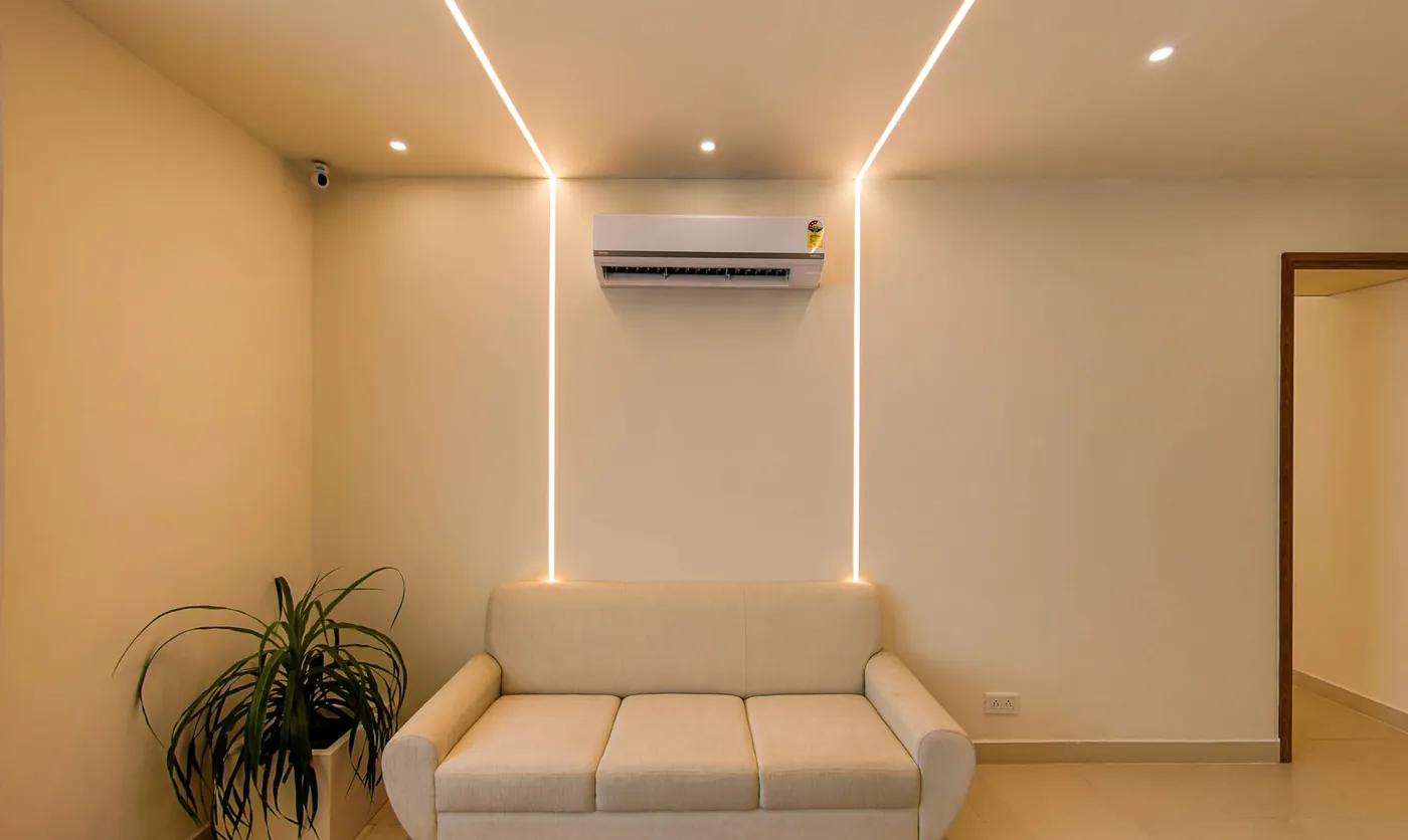 The living area of the 3 BHK penthouse with cove lighting tracing the ceiling